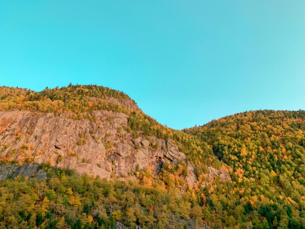 Breathtaking autumn landscape of Lake Placid's mountainous terrain with vibrant foliage.