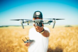 A person holds a DJI Mavic drone, for searching bird to take photo.
