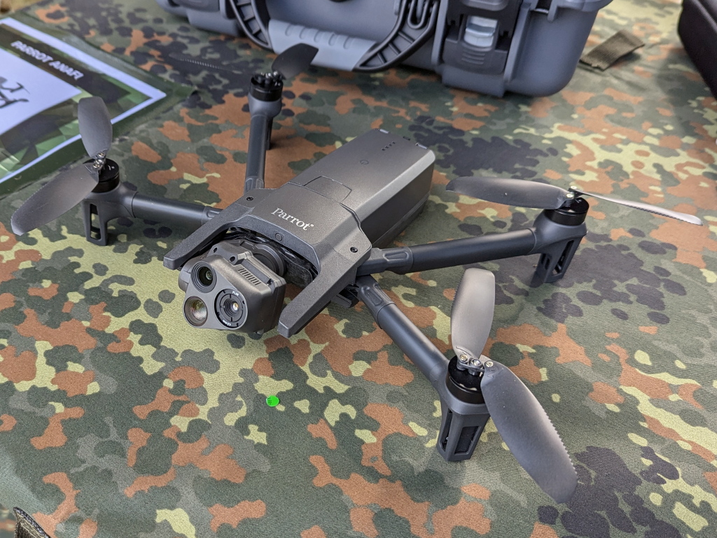 A grey Parrot Anafi USA drone rests on a camouflage surface.