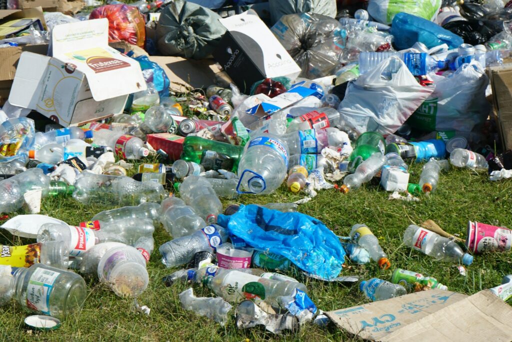 Blue plastic bottle on green grass field.
