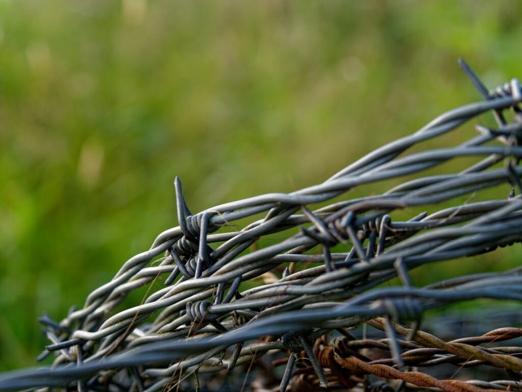 A bunch of barbed wire sitting on top of a field.
