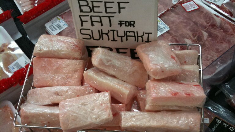 Chunks of beef fat displayed in a meat store