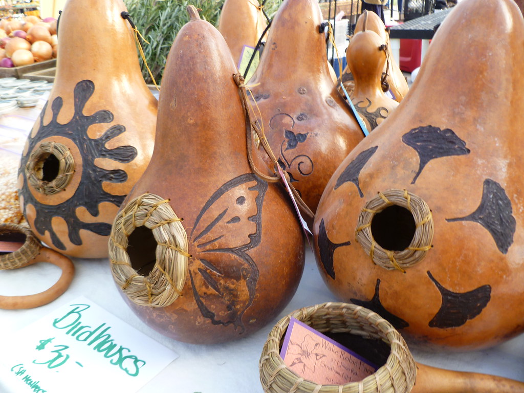 Decorated gourd birdhouses on display.