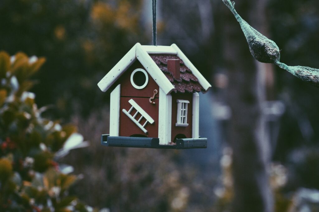 A closeup photo of red and white bird house.