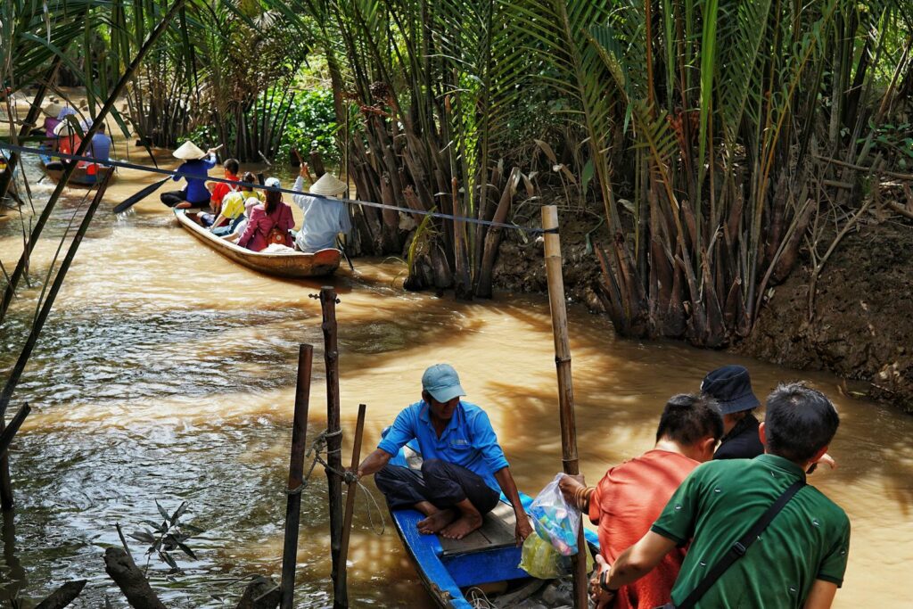 Discover the beauty of a tropical river tour with traditional canoes surrounded by lush greenery.
