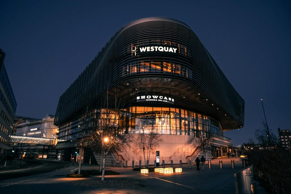 Illuminated night view of Westquay Shopping Centre in Southampton, showcasing urban architecture.