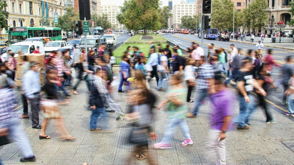 Busy road scene with people crossing at intersection