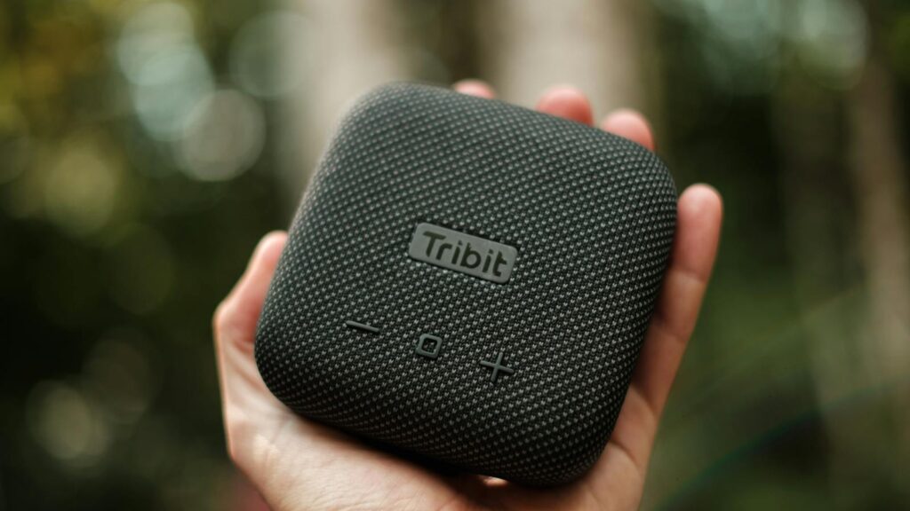 Hand holding a portable speaker
