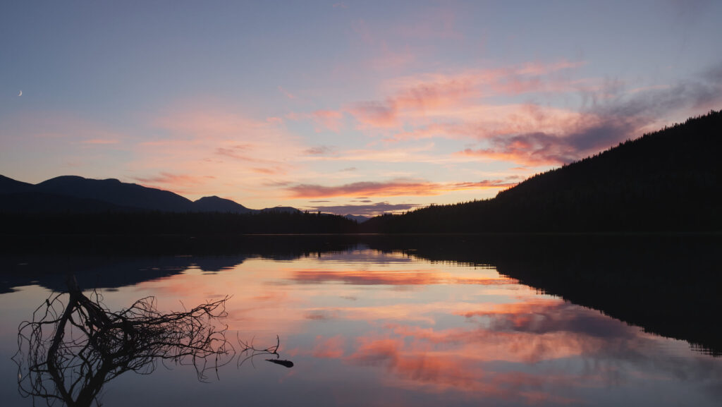 Civil twilight sunset over the calm waters of Sandy Lake