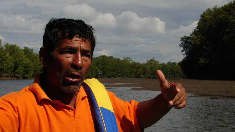 Man from the Cayapas community explaining something with expressive gestures