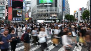 Crowd of people crossing a busy intersection