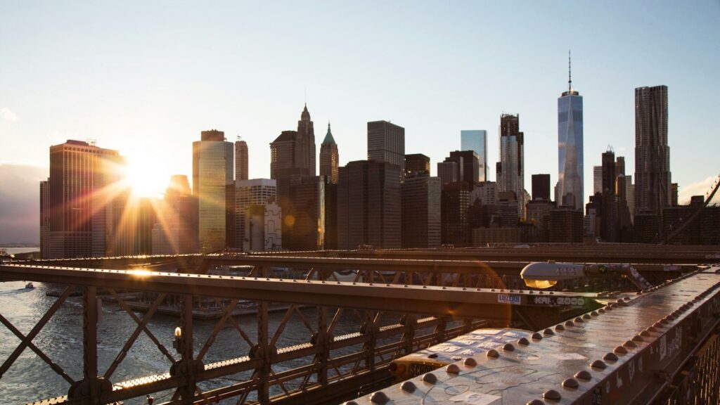 Metal bridge with urban skyline in the background on a bright sunny day