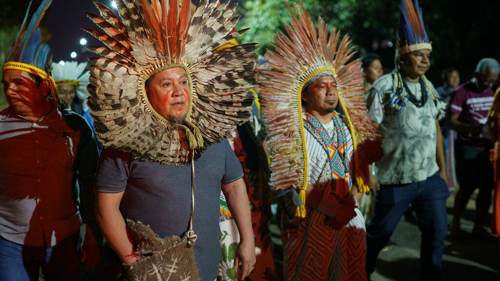 Rikbaktsa tribe members wearing traditional harpy eagle feather headdresses