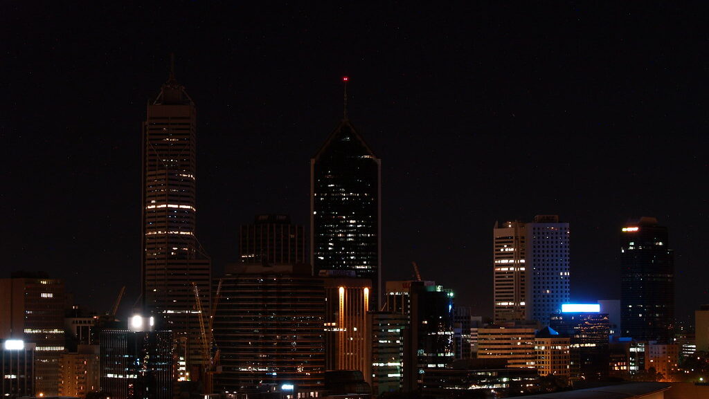 City skyline with building lights dimmed for Earth Hour