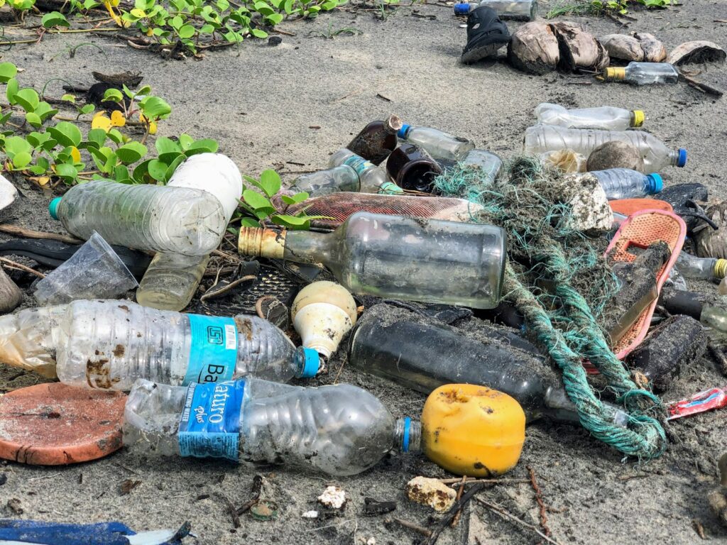 Various pieces of litter are scattered on a sandy beach.