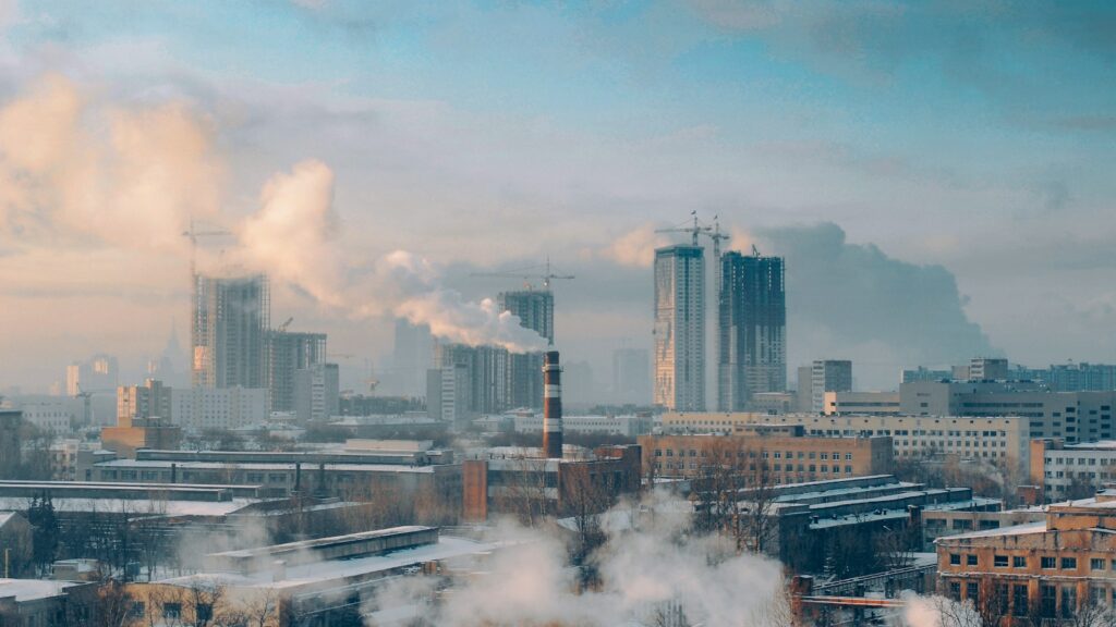 Skyline of modern city with smoke plumes