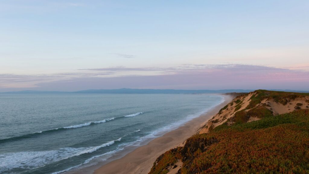 Scenic view of Monterey Bay, California, with ocean waves and coastal cliffs