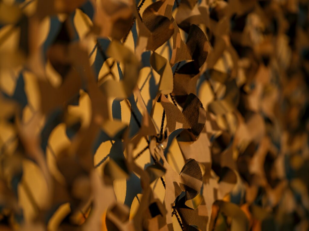 A close up of a wall with a bunch of leaves on it