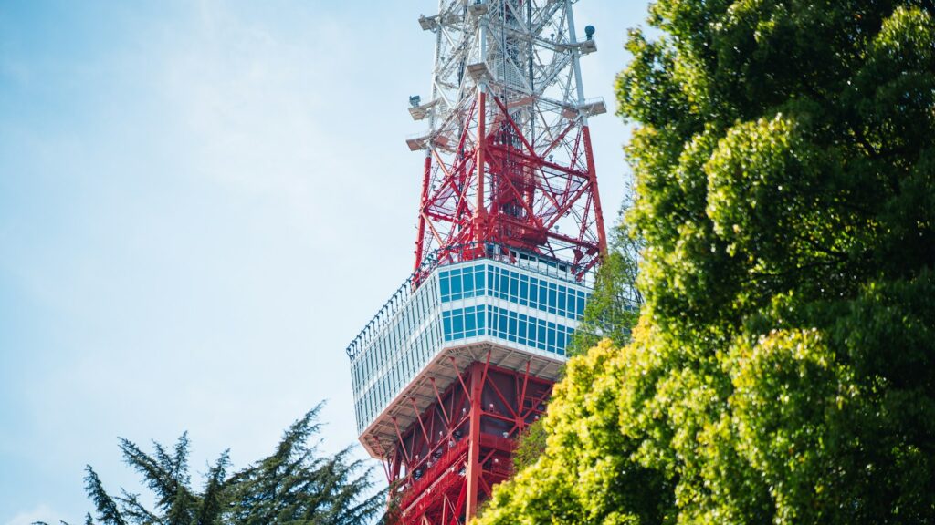 Radio tower standing near trees
