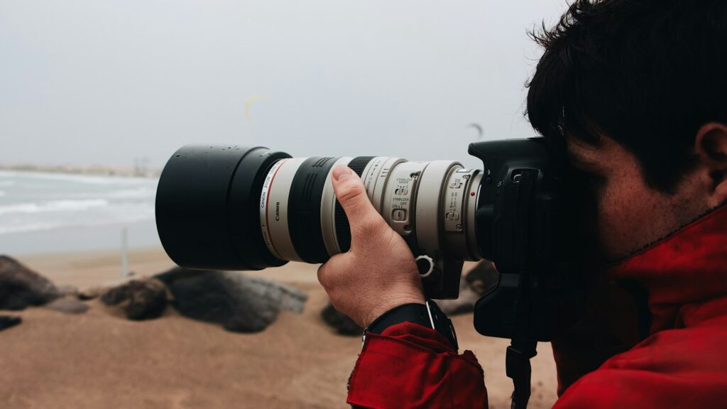 Man looking into camera with telephoto lens