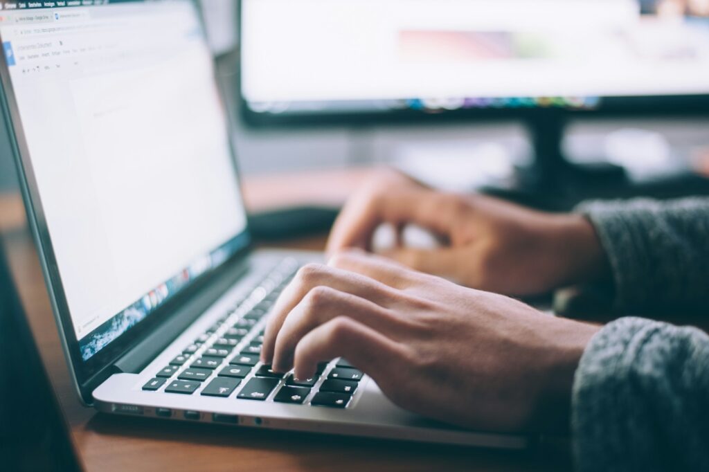 A person researches something on a laptop.