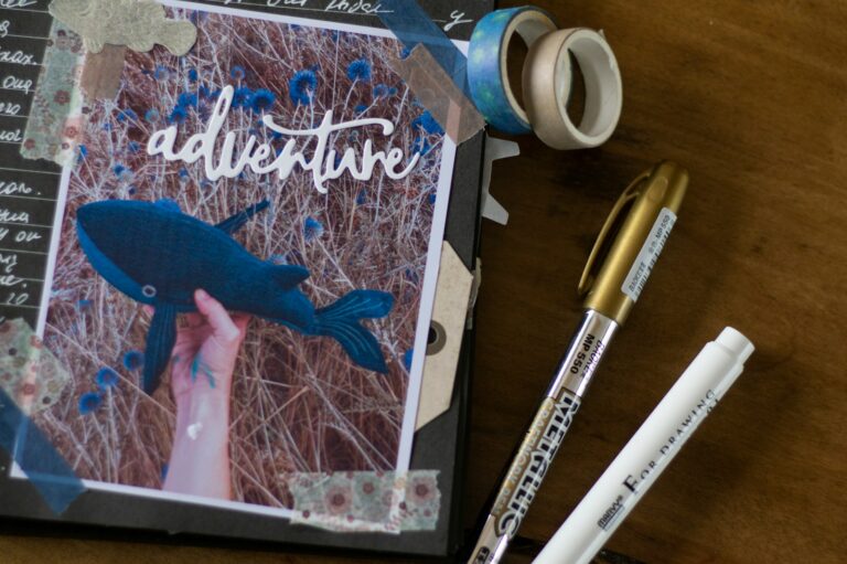 A birdwatcher's logbook open to a page with a whale and the word "adventure."