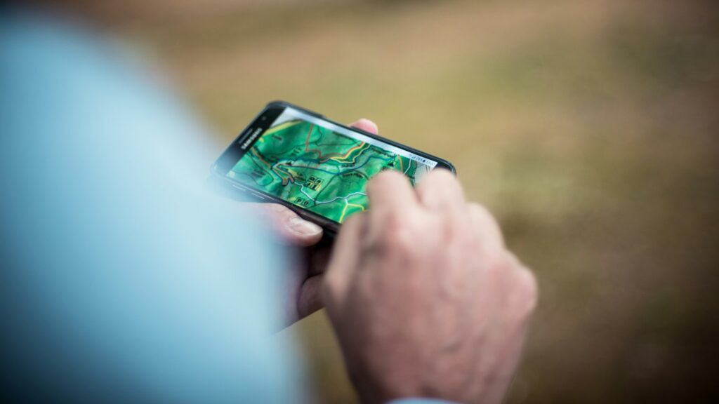 Person holding a smartphone with a GPS map