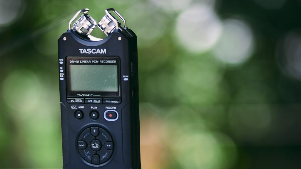 Recorder device in focus with blurred forest background