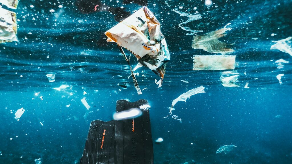 Water pollution with plastic waste and wrappers scattered on the surface