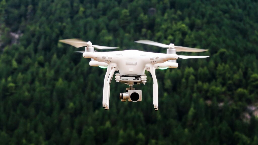 Drone flying over dense green forest