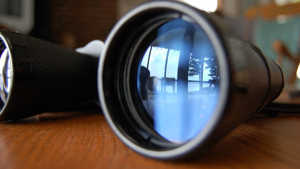 Binoculars resting on wooden surface