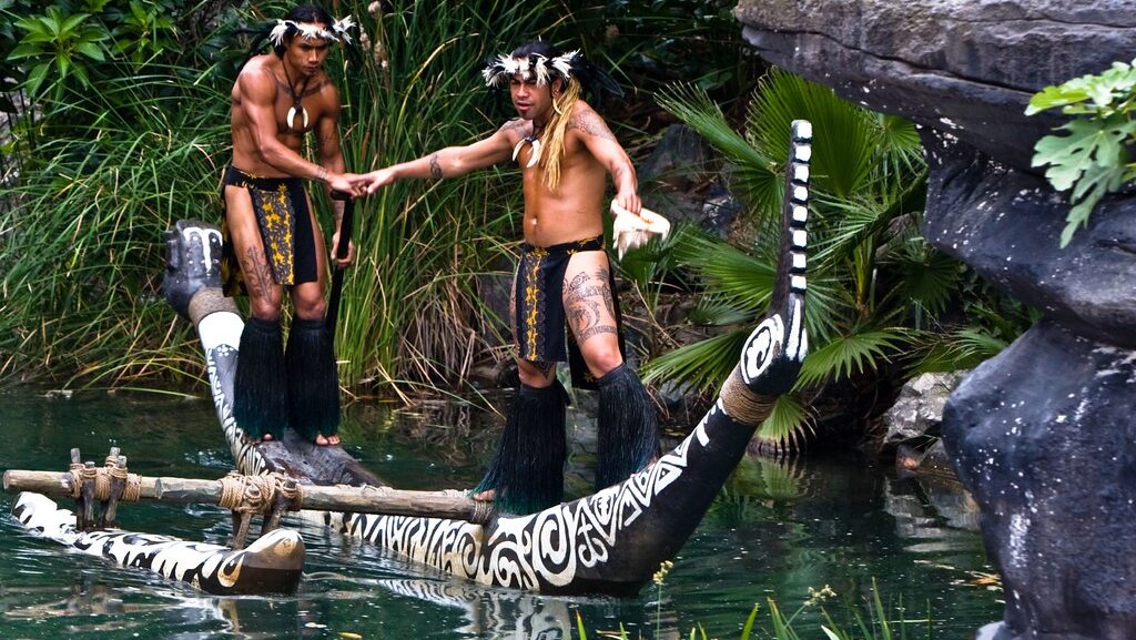 Two men standing on a wooden Polynesian boat