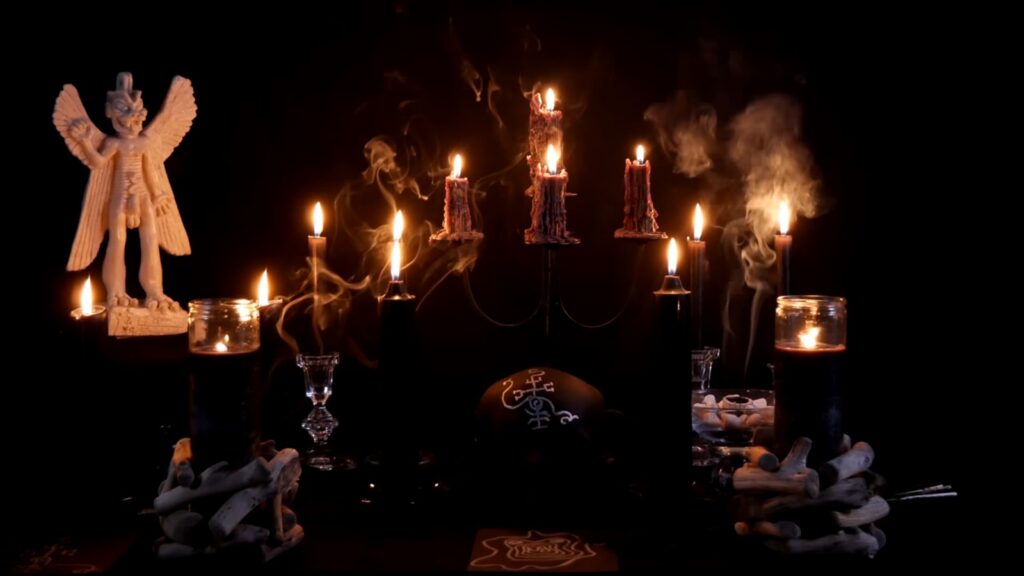 A dimly lit scene features an angelic figure and burning candles with smoke.