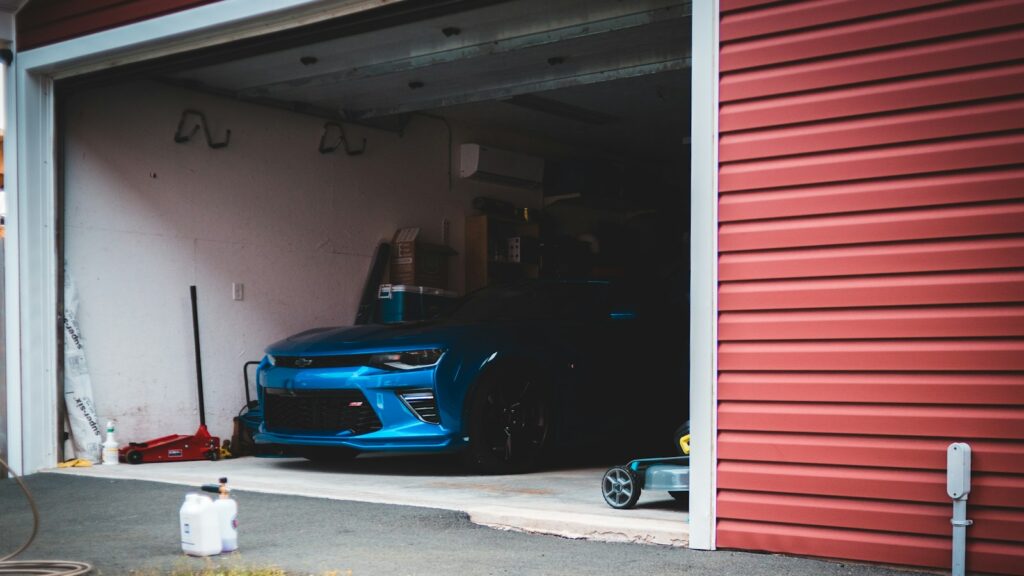 Blue car parked inside a residential garage