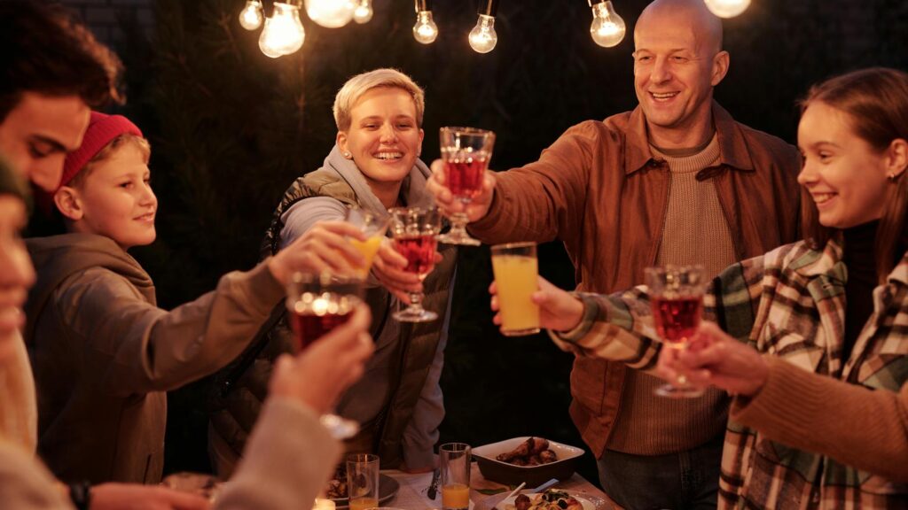 Group toast with glasses during gathering