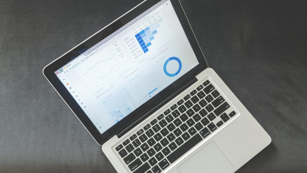 Laptop screen displaying data charts and analytics