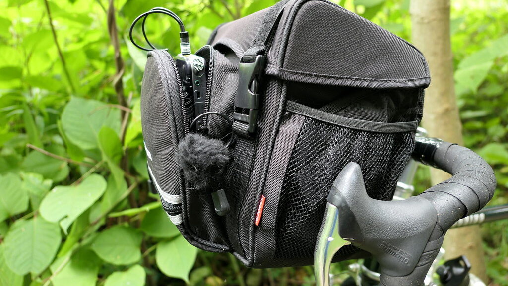 Audio recorder secured in a bag mounted on bicycle handlebars