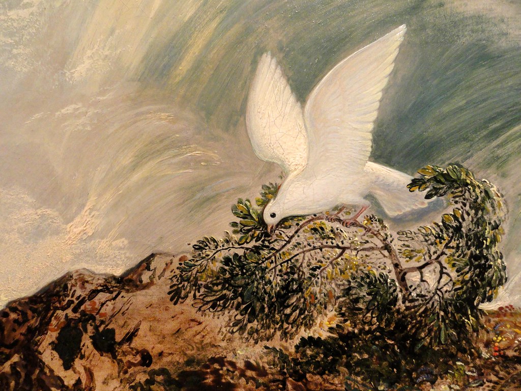 An art piece shows a white dove with outstretched wings landing on a green tree branch.