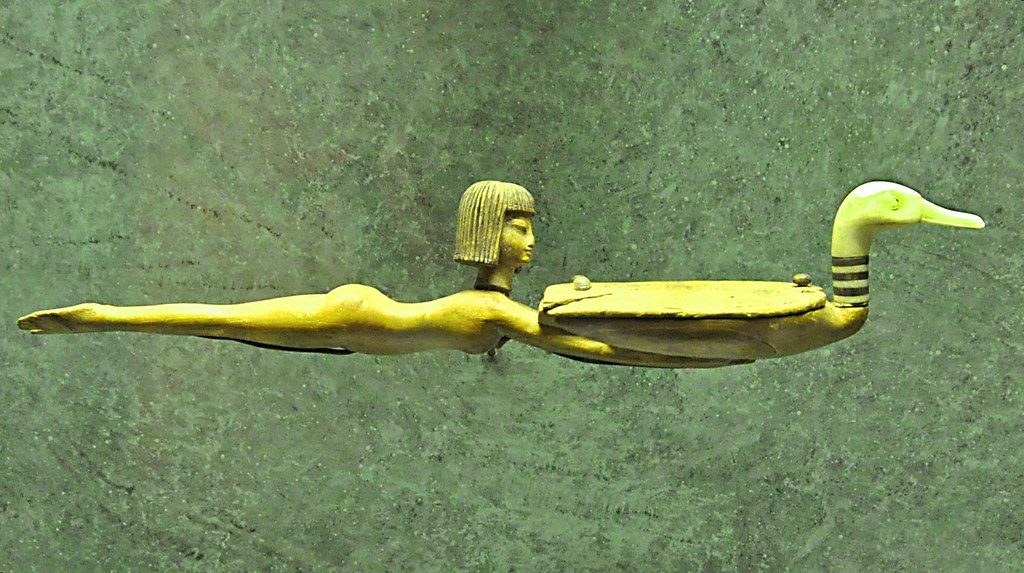 An ancient Egyptian cosmetic spoon is shaped like a swimming girl holding a duck.