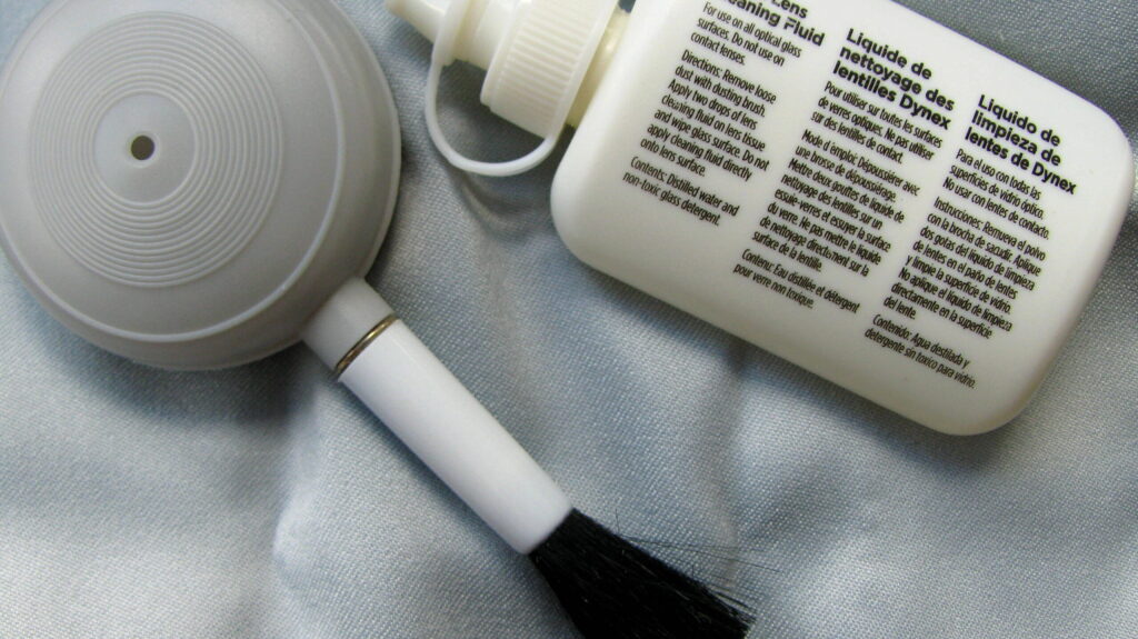 Lens cleaning tools placed over a microfiber cloth