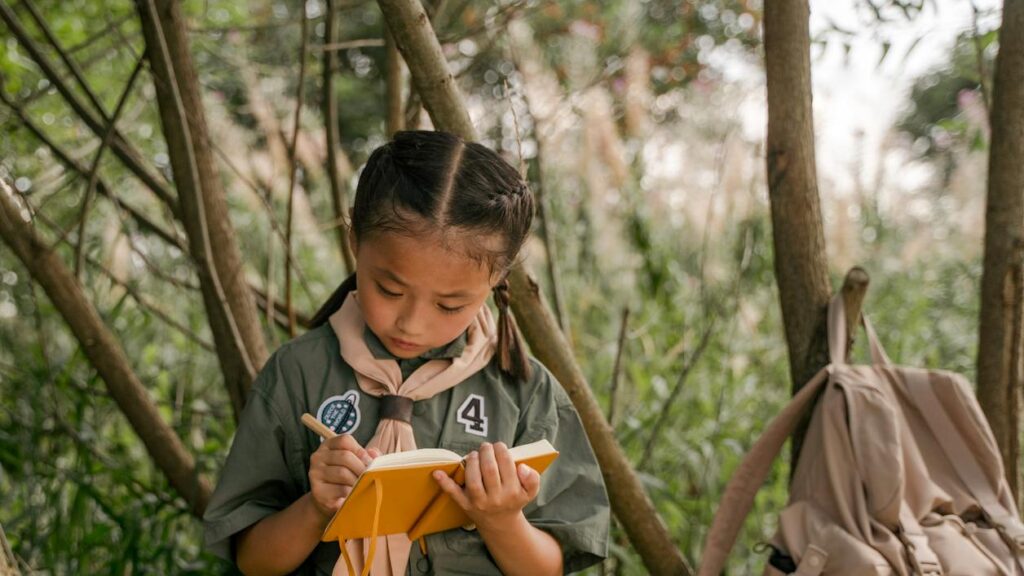 A young girl writing on her journal