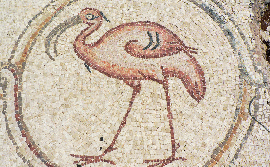 A beautiful mosaic depicts a stylized flamingo with soft pink and brown tiles.