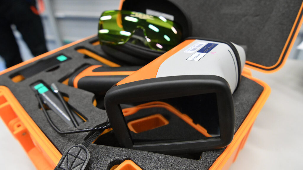 Portable XRF analyzer resting on its protective carrying case