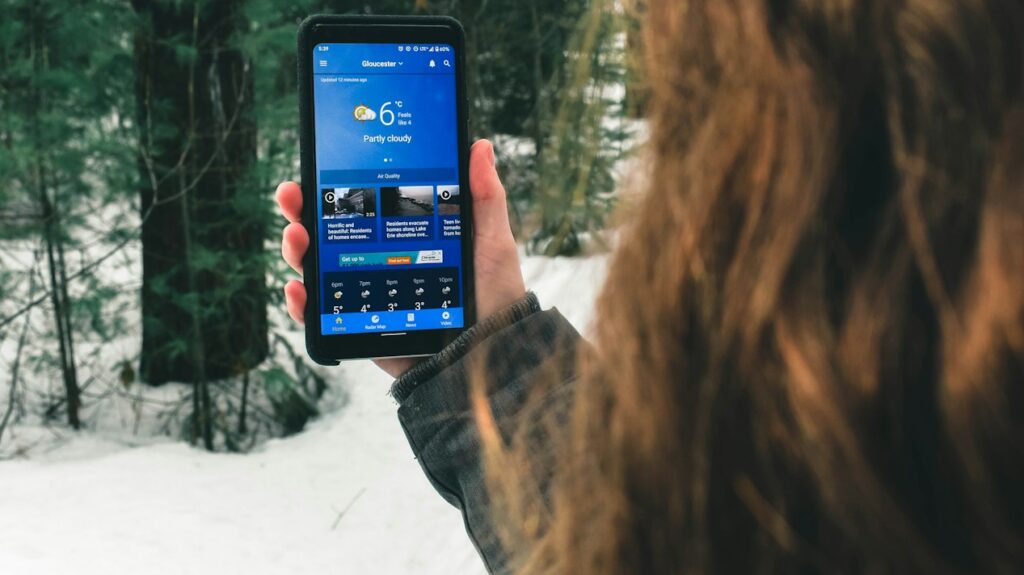 Person checking weather forecast on smartphone