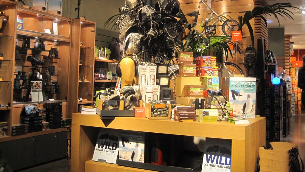 Outdoor gear store display featuring a variety of binoculars and other wildlife gear