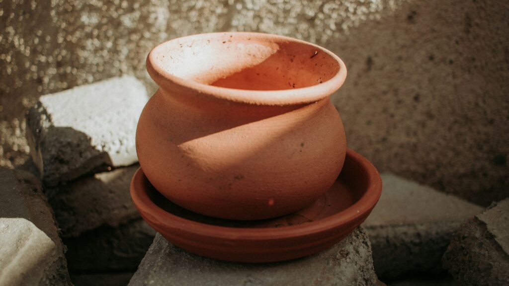 Traditional clay pot placed above a matching clay bowl