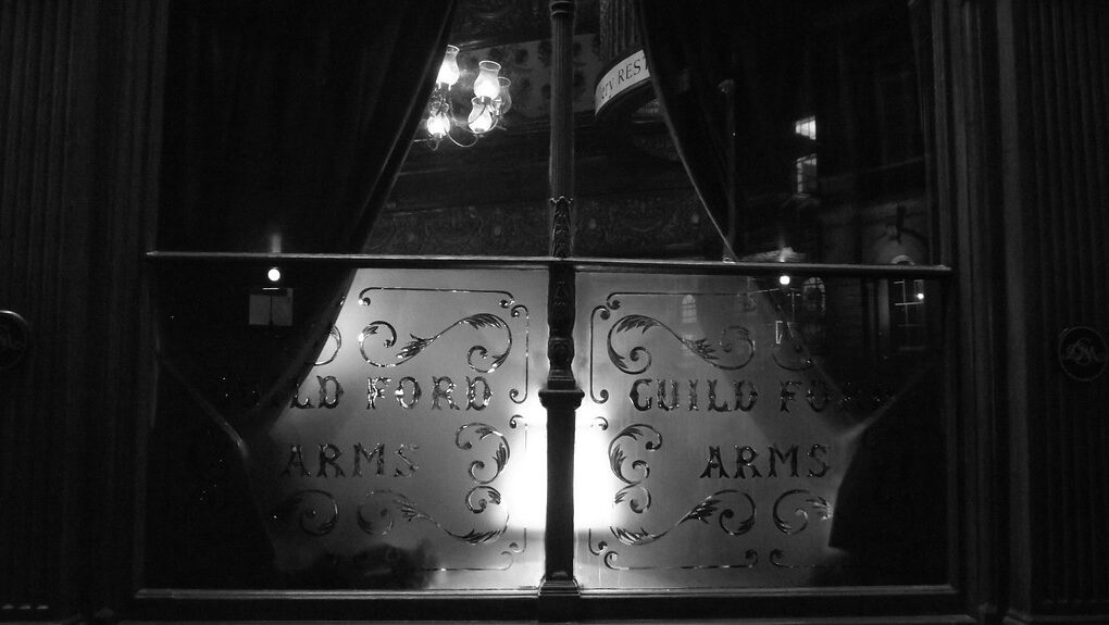 Pub window featuring decorative acid-etched lettering