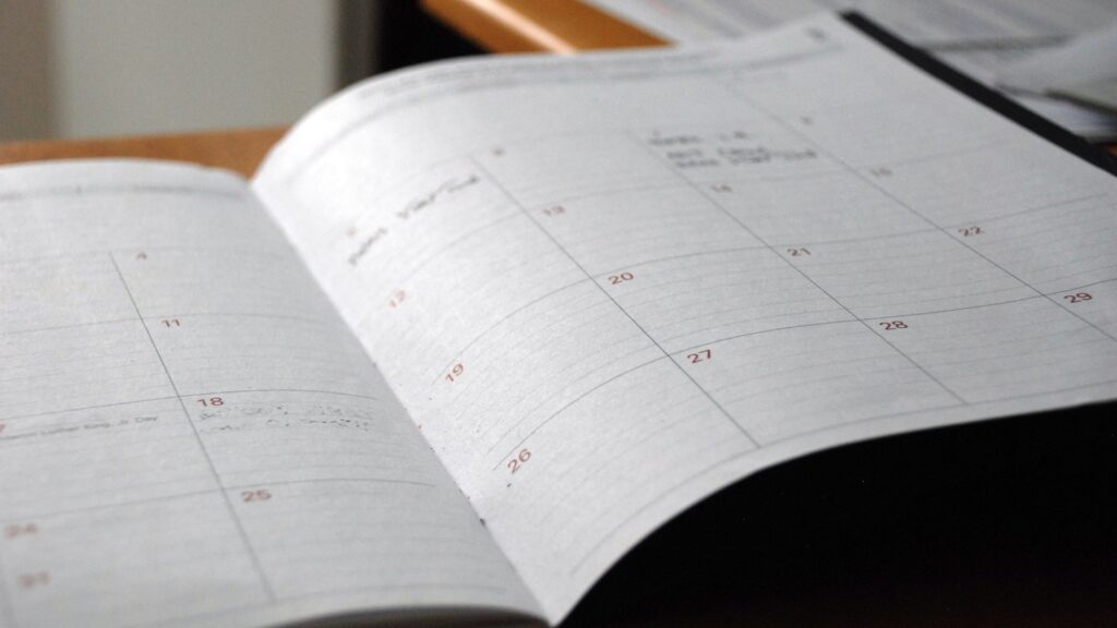Open schedule planner with handwritten notes and daily tasks