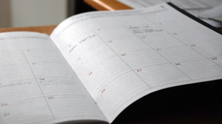 Open schedule planner with handwritten notes and daily tasks