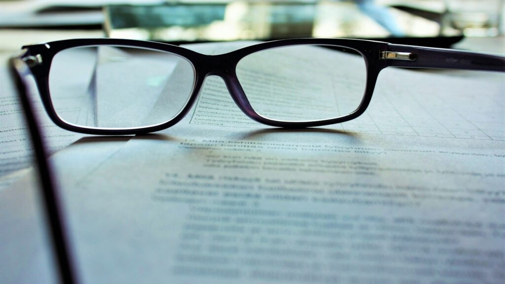 Eyeglasses lying on a paper document
